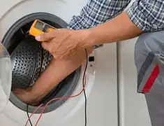 Washing machine repair technician testing a front-load washer with diagnostic tools in Minneapolis, MN